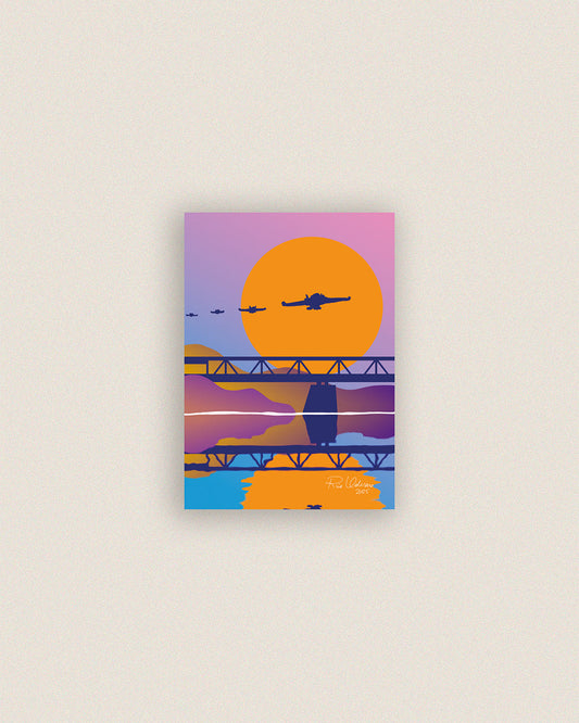 Rovaniemi-aiheisen postikortin värikäs kuvitus, jossa näkyy Kemijoki, Ounaskosken silta ja neljä Hornet-hävittäjää taivaalla.