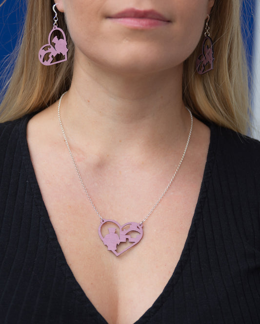 Vaaleanpunaisen sävyinen Oulu-kaulakoru. Korussa on siro hopeinen kaulaketju.