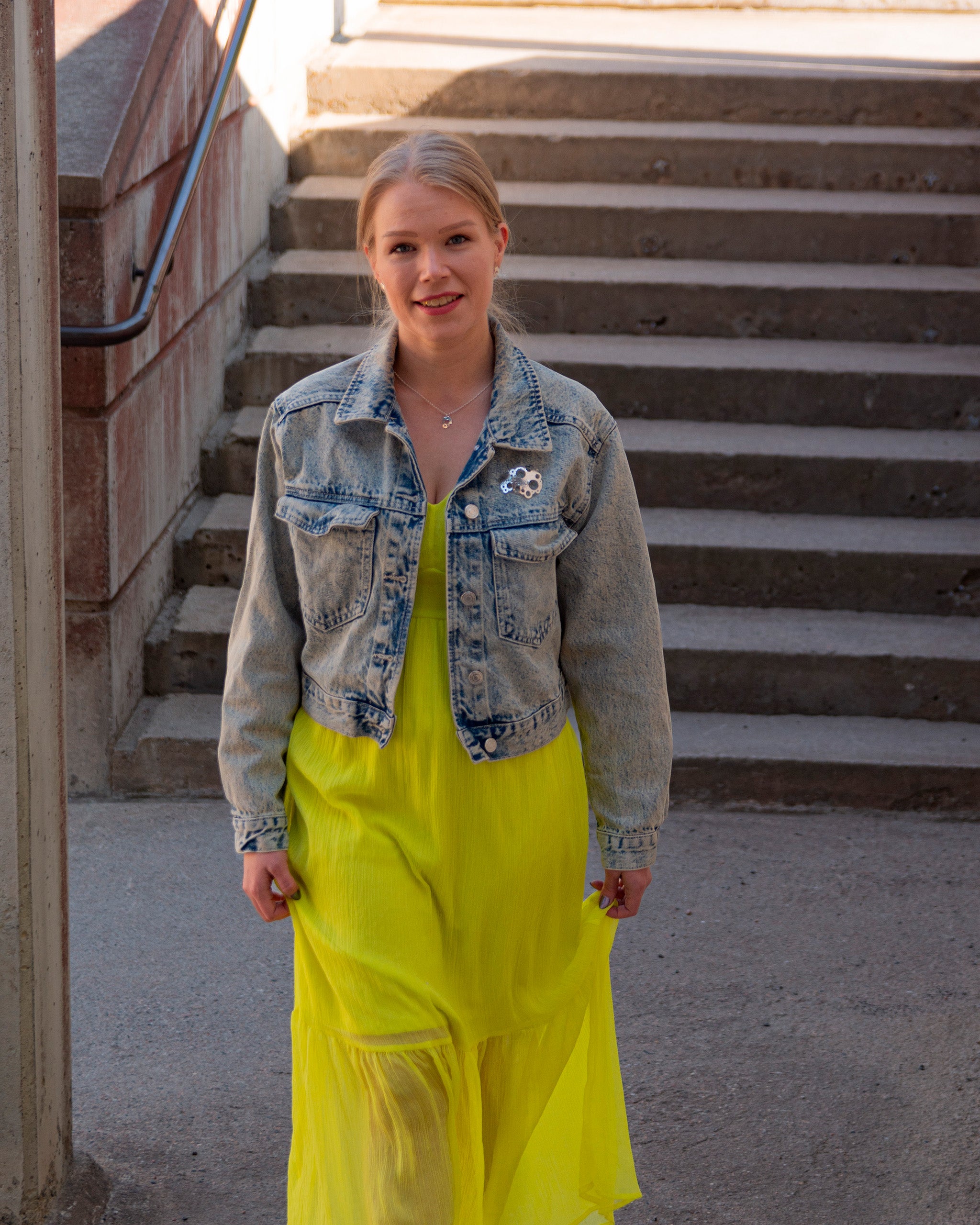 Näyttävä hopeinen rintaneula kiinnitettynä naiset farkkutakkiin.